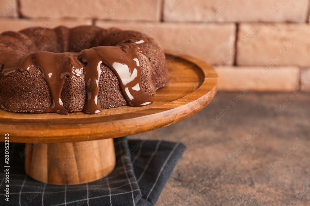 Dessert stand with tasty chocolate cake on table