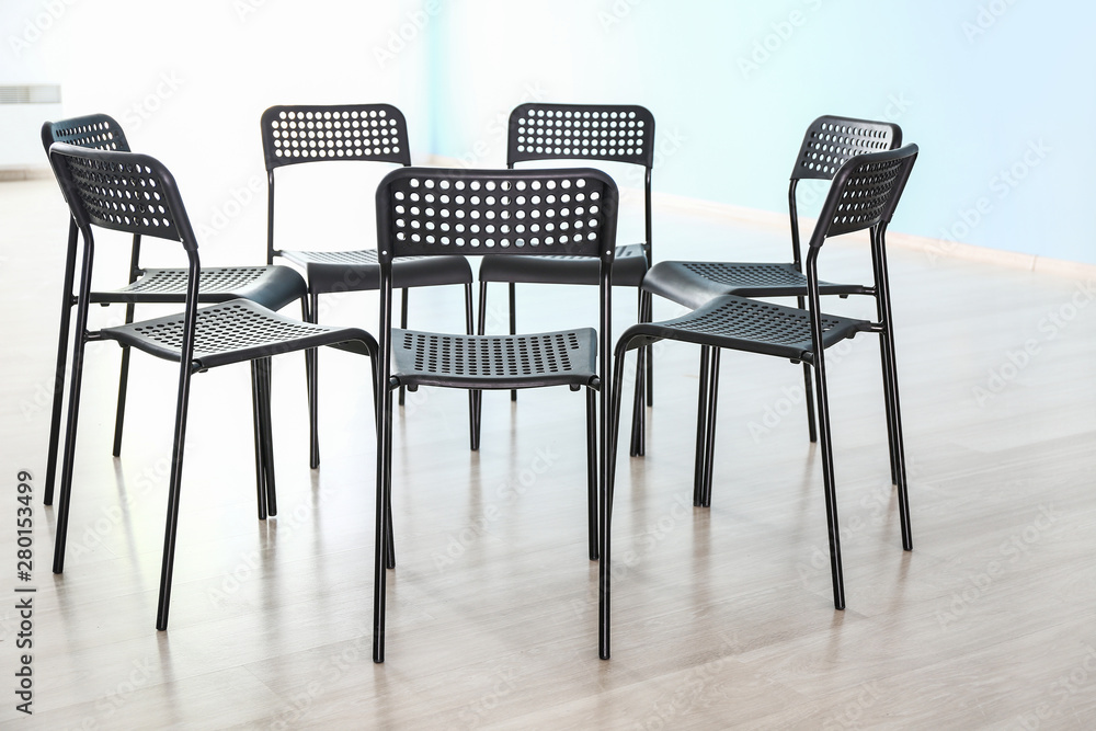 Empty chairs prepared for group therapy in psychologists office