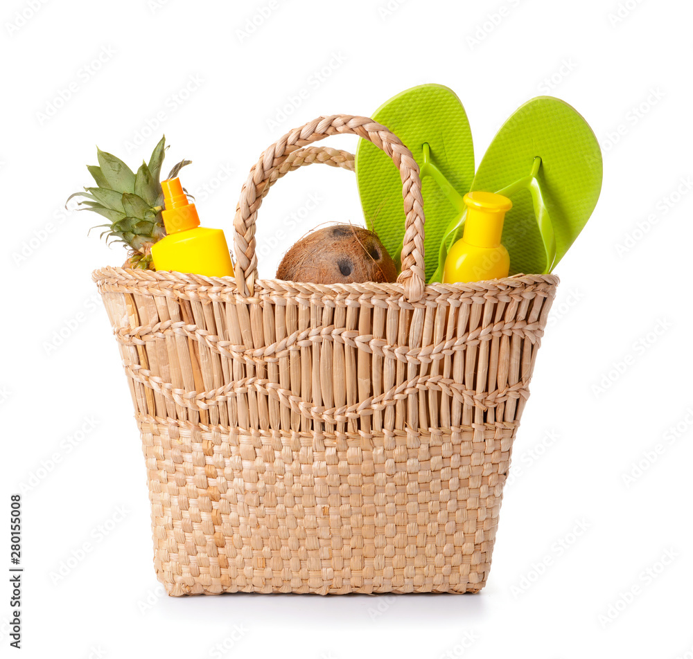 Beach bag and accessories on white background