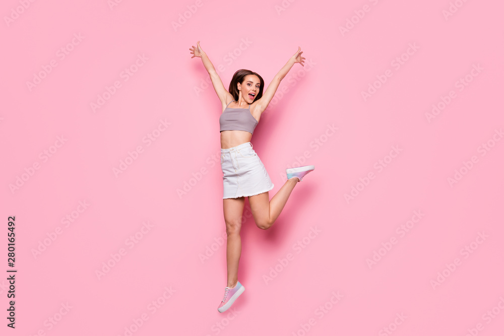 Portrait of attractive girl raising hands screaming isolated over pink background