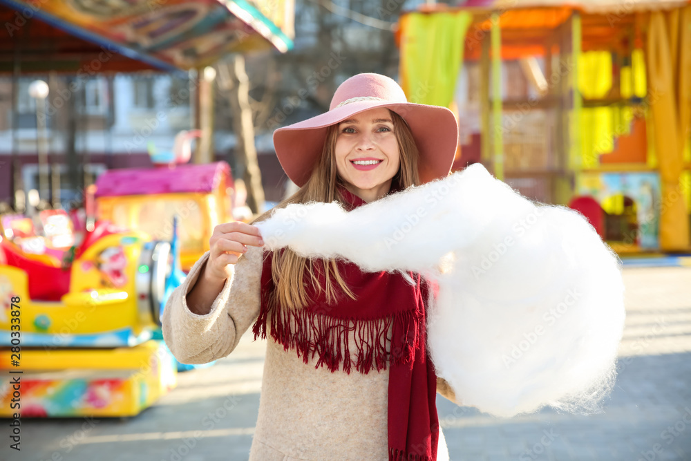 Woman with sweet cotton candy outdoors