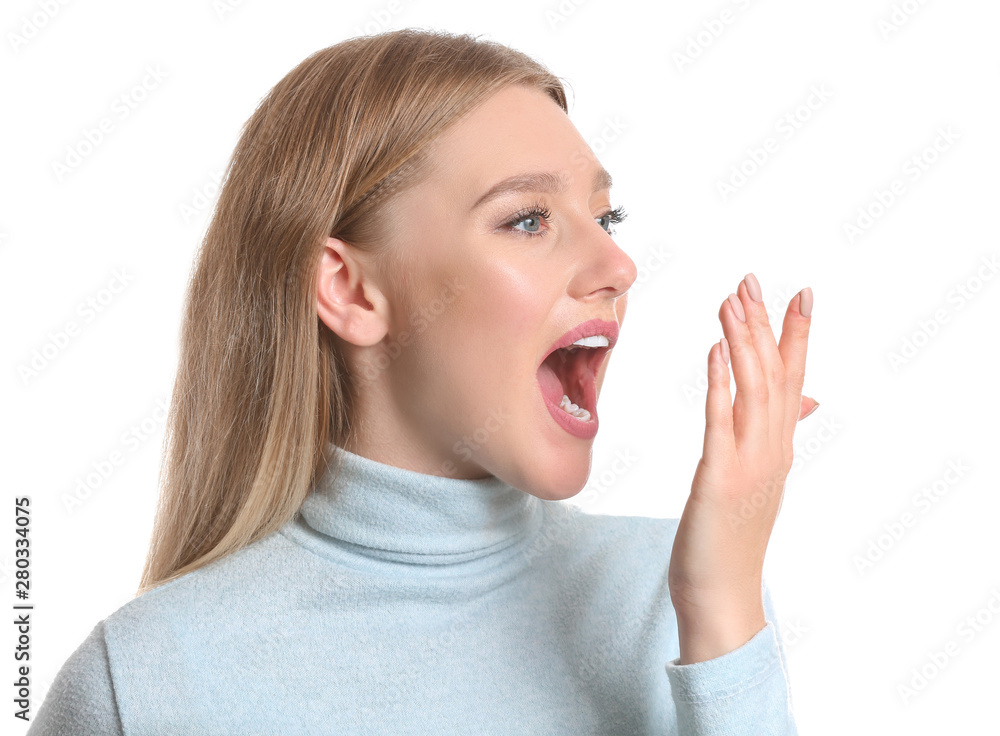 Woman checking freshness of her breath on white background