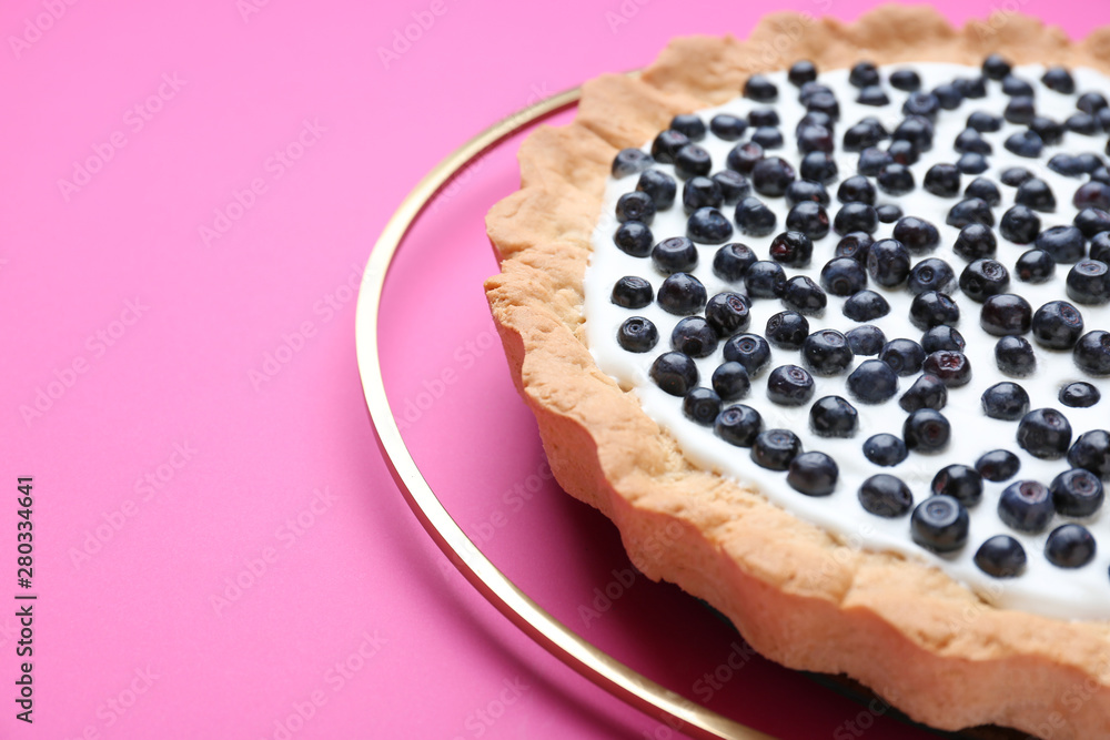 Tasty bilberry pie on color background, closeup