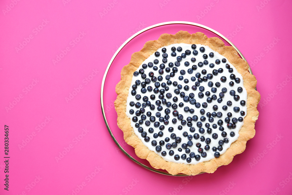 Tasty bilberry pie on color background