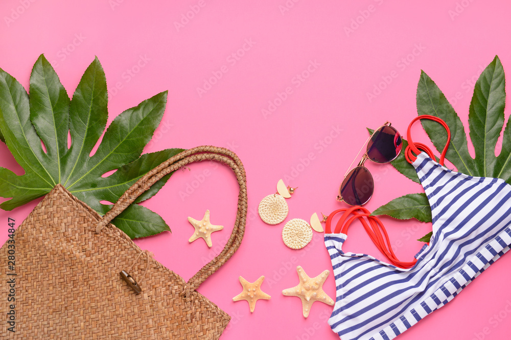 Composition with beach accessories on color background