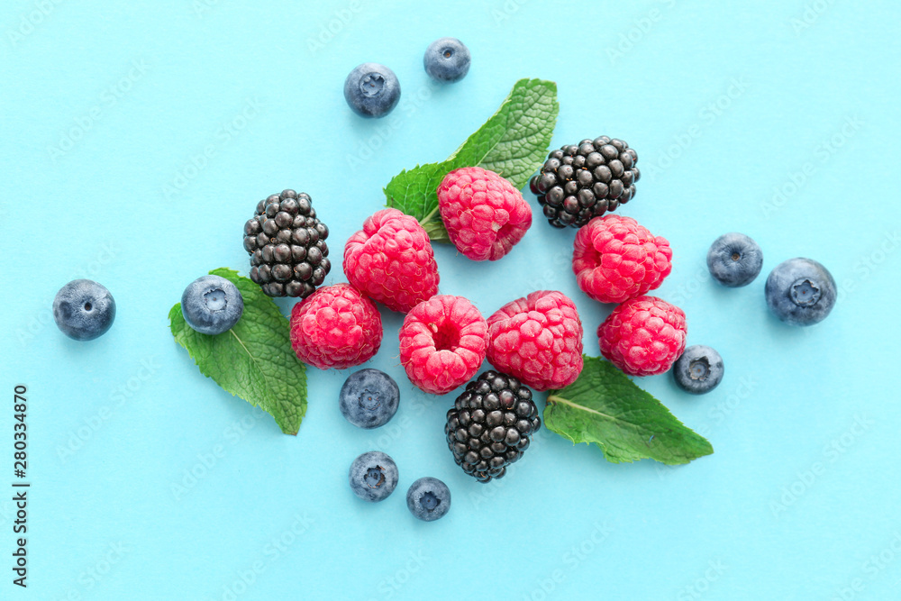 Sweet ripe berries on color background