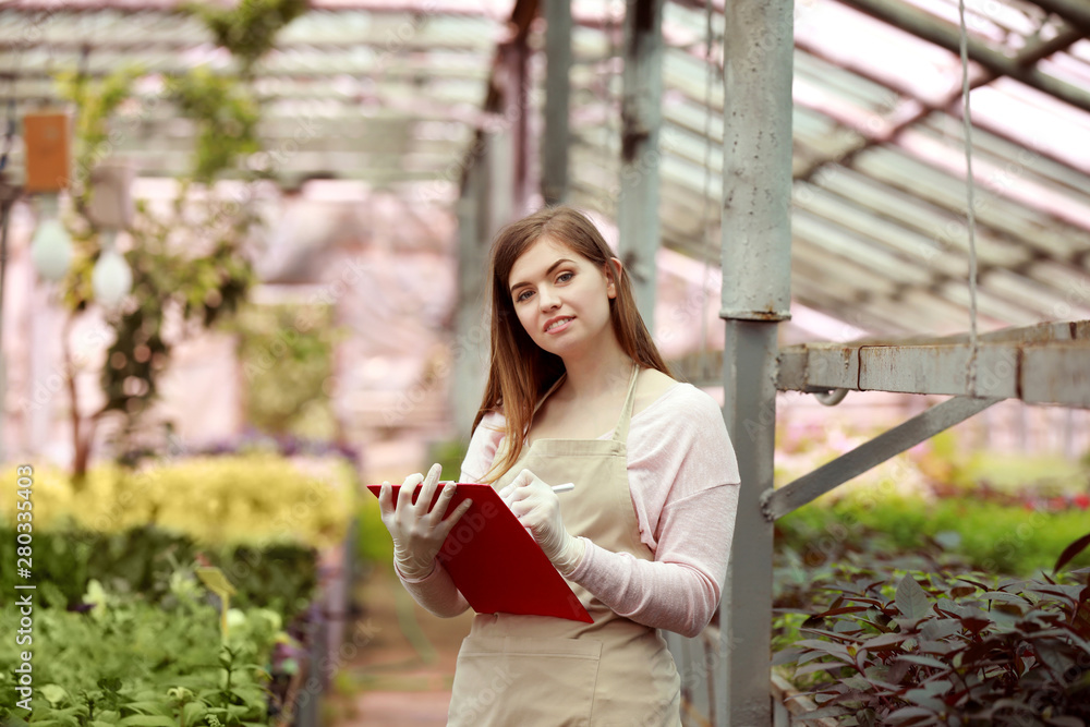 Portrait of female agricultural engineer in greenhouse