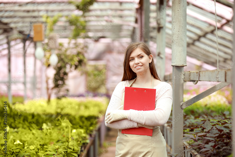 Portrait of female agricultural engineer in greenhouse