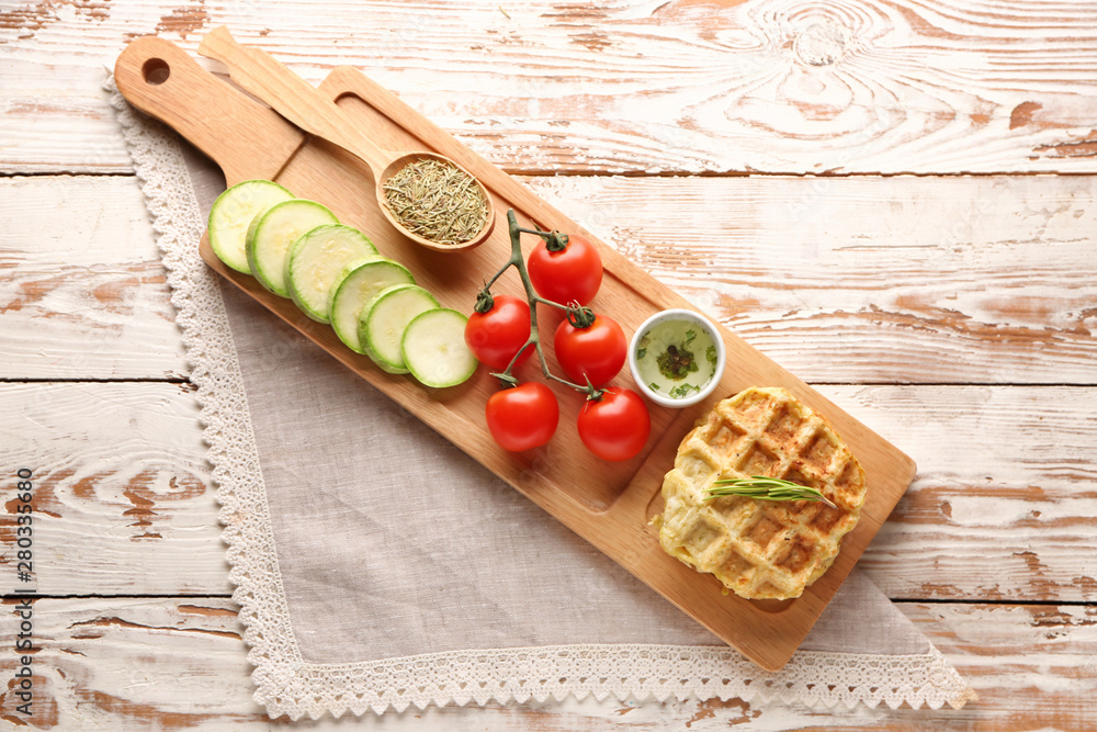 Tasty squash waffles with vegetables on wooden table