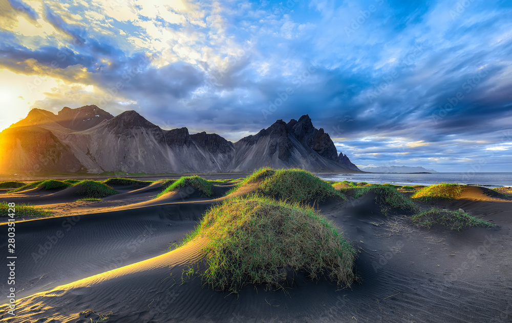 Fantastic sunny day and gorgeous black sand dunes on Stokksnes cape in Iceland.