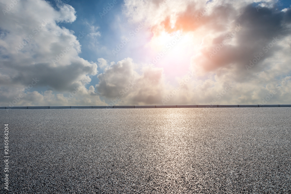 Asphalt road and beautiful clouds landscape at sunset