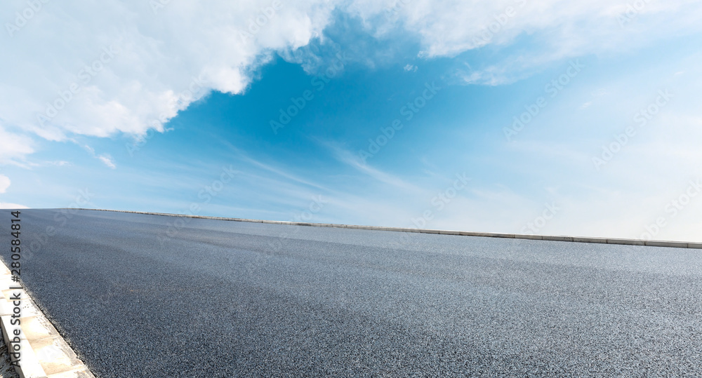 Asphalt road and blue sky with white clouds landscape