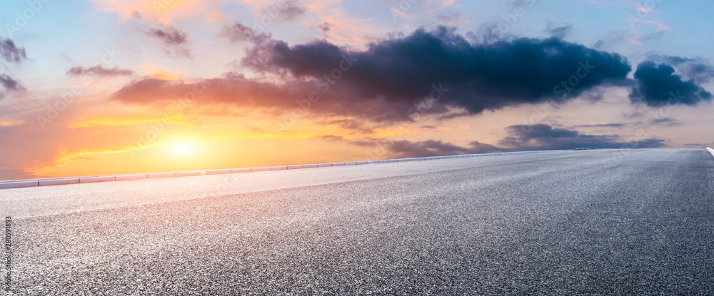 Asphalt highway and beautiful clouds landscape at sunset