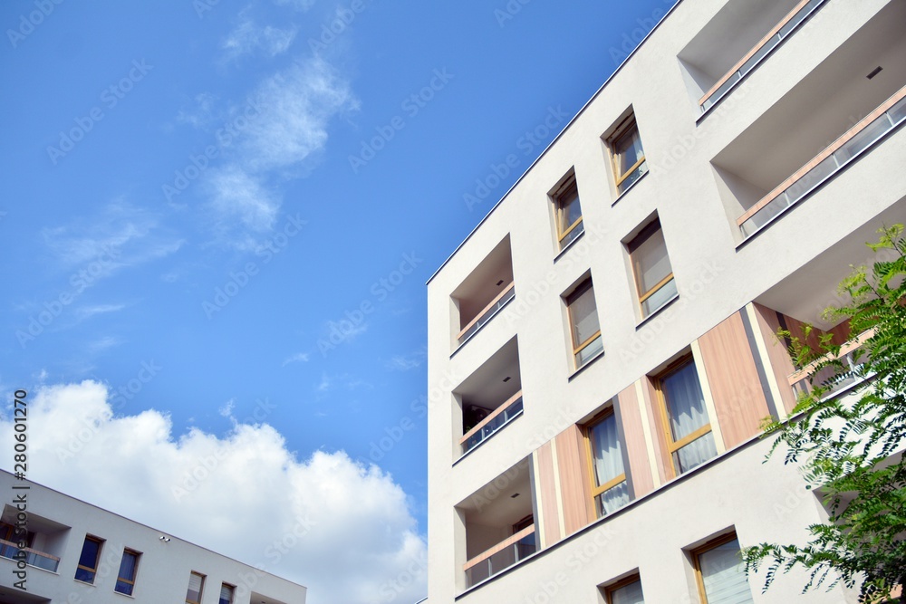 modern apartment building with blue sky and clouds