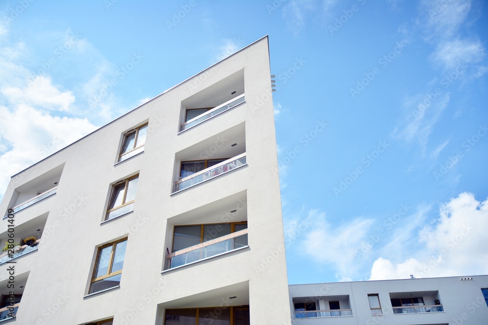 modern apartment building with blue sky and clouds