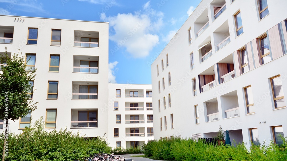 Modern multi-storey luxury housing concept. Modern apartment building with blue sky and clouds.