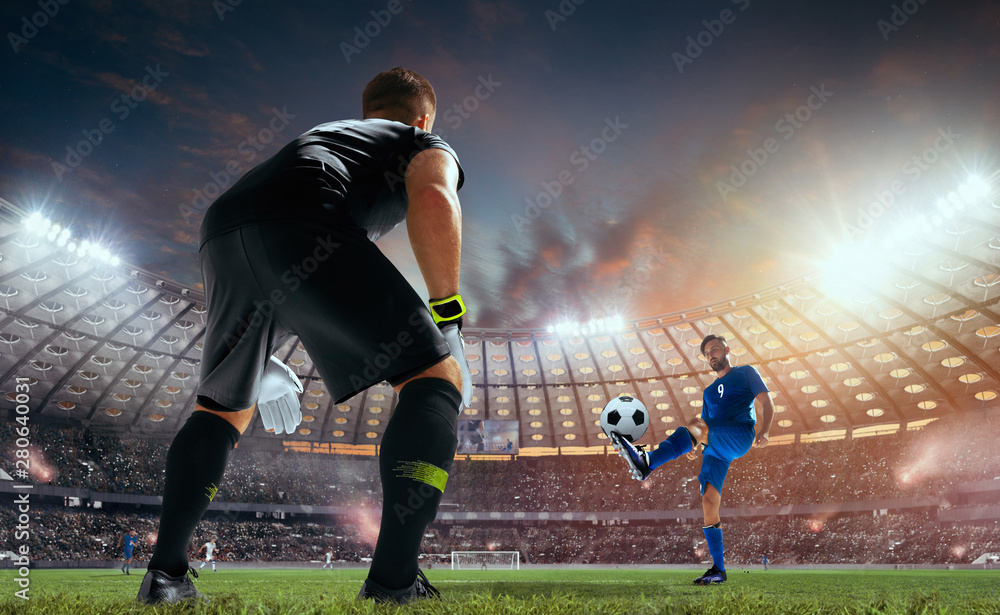 Soccer players in action on professional stadium on sunset.