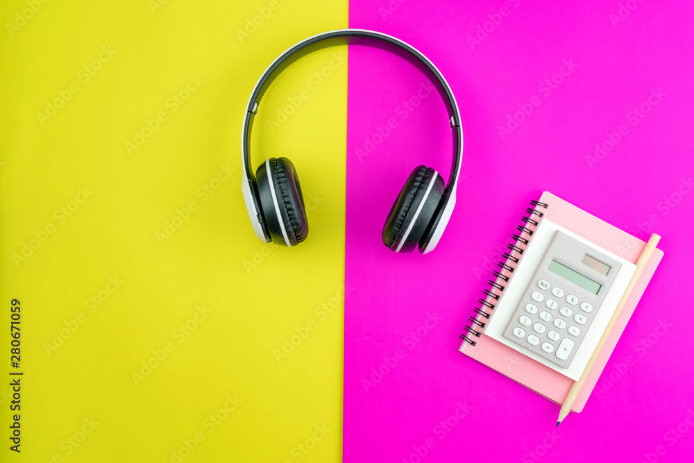 Headphone with Business paper note,pencil and business objects on colorful paper background