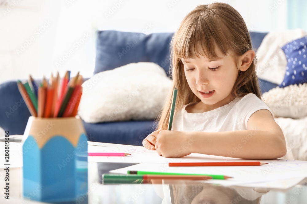 Cute little girl drawing at home