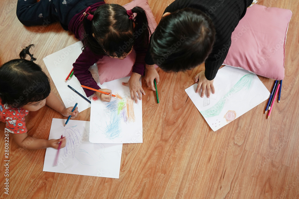 Children drawing and painting color on the paper with happiness. Education and little artist concept