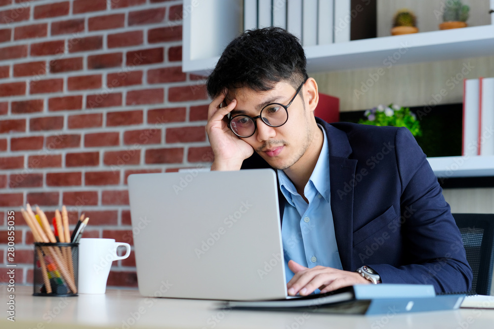 Young asian businessman concentrate on working with laptop computer at office, Asian office man comt