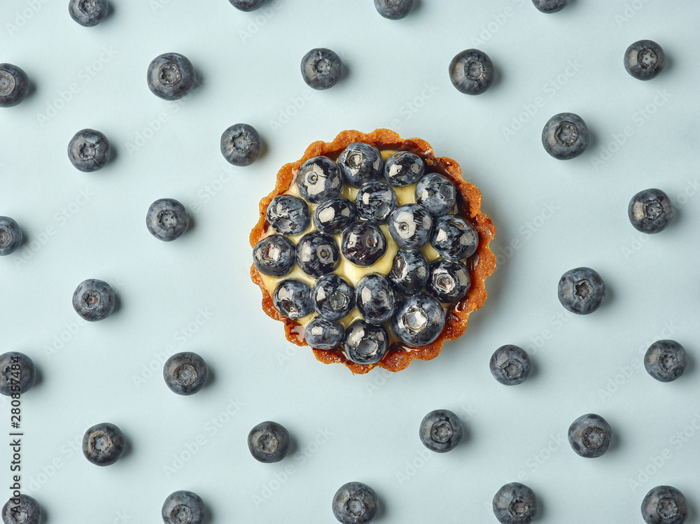 blueberry tart on light blue background