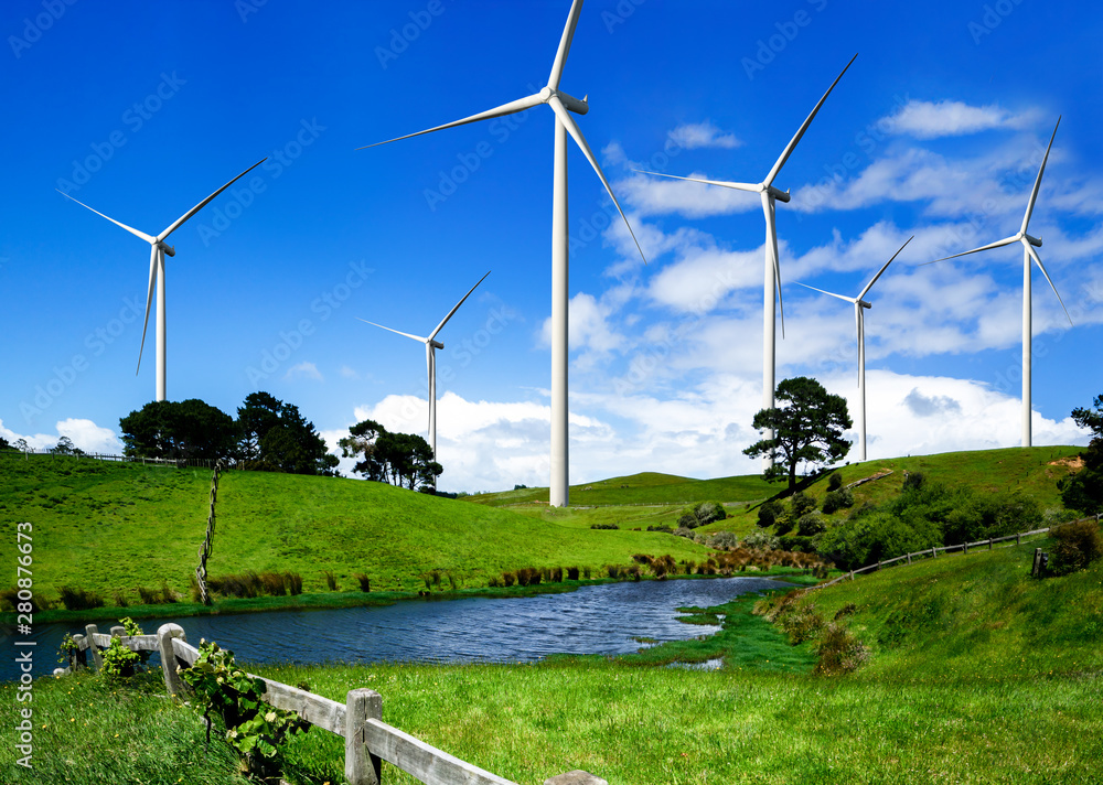 Wind turbine farm power generator in beautiful nature landscape for production of renewable green en