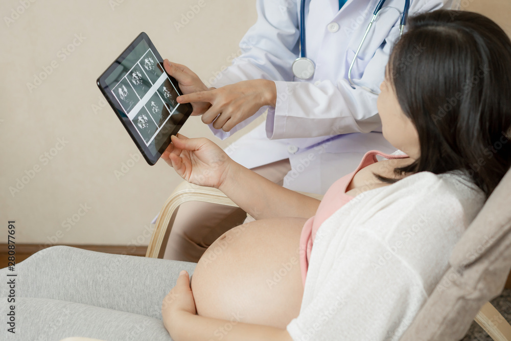 Happy pregnant woman visit gynecologist doctor at hospital or medical clinic for pregnancy consultan