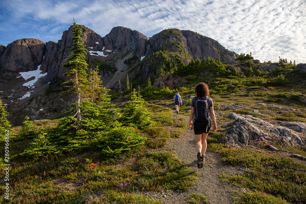 Adventurous girl hiking the beautiful trail in the Canadian Mountain Landscape during a vibrant summ