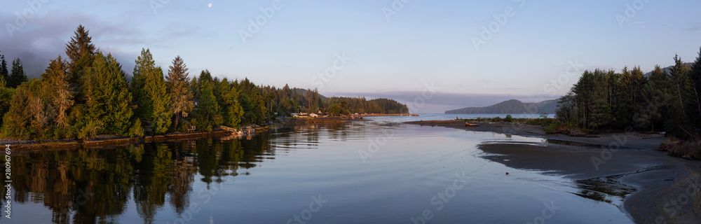 Beautiful Panoramic View of a river joining the ocean in a small town during a cloudy and sunny summ