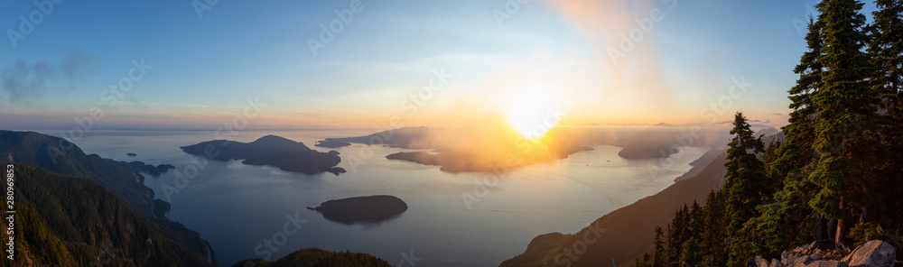 Beautiful Panoramic View of Canadian Mountain Landscape covered in clouds during a vibrant summer su