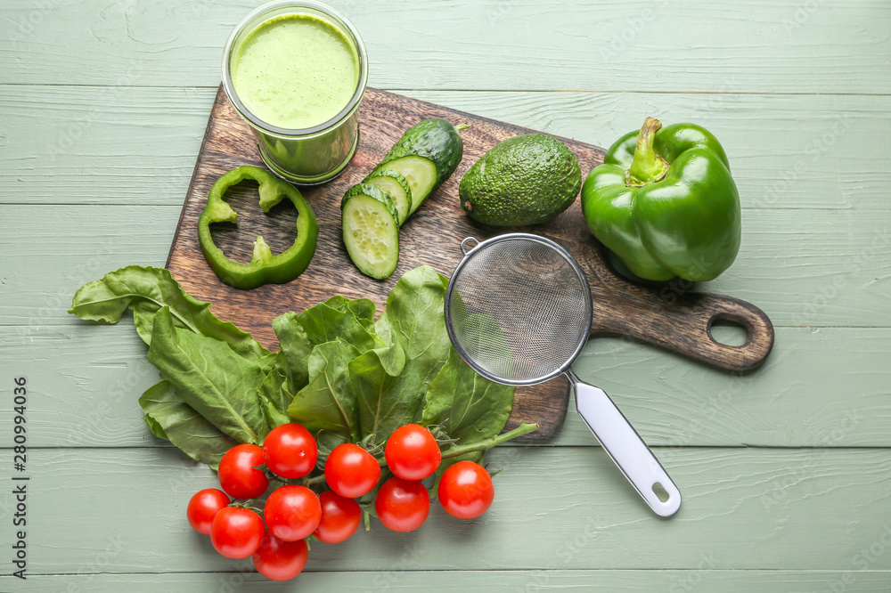 Glass of fresh healthy smoothie and ingredients on wooden background