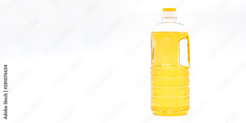 A bottle of yellow salad oil on a white background