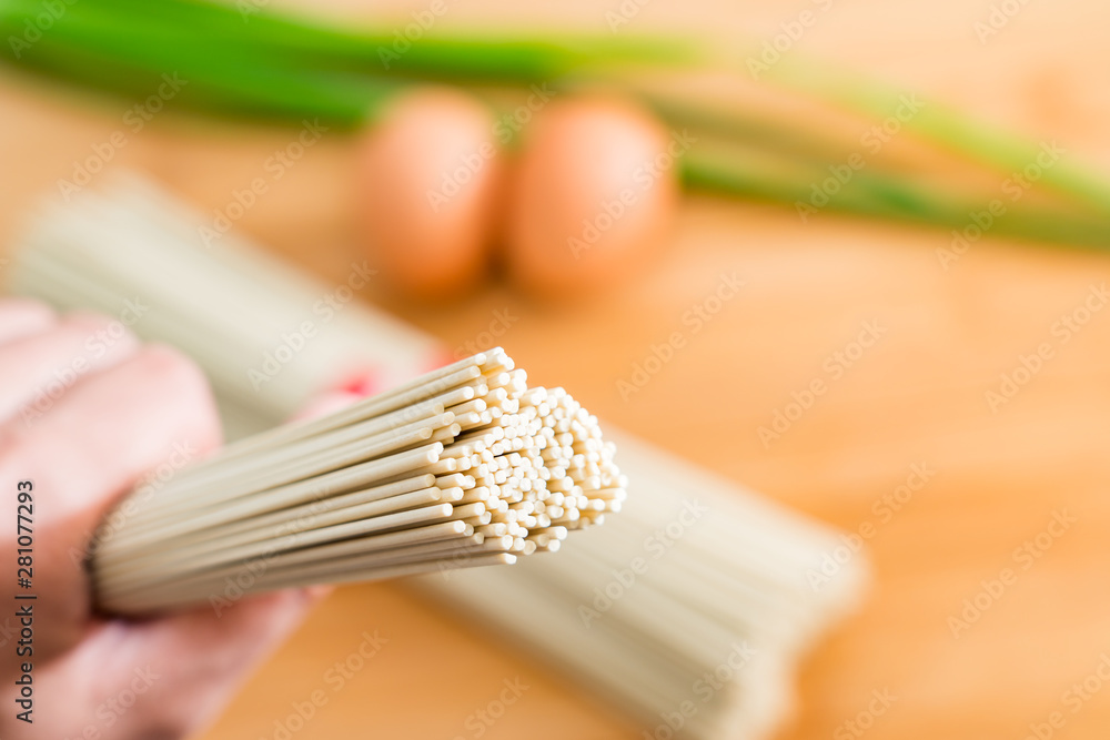 Fast food noodles and eggs and shallots on the board