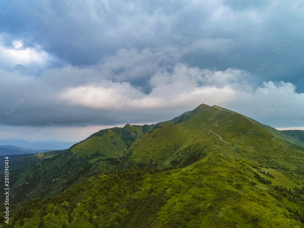 The beautiful mountain landscape on the cloudscape background