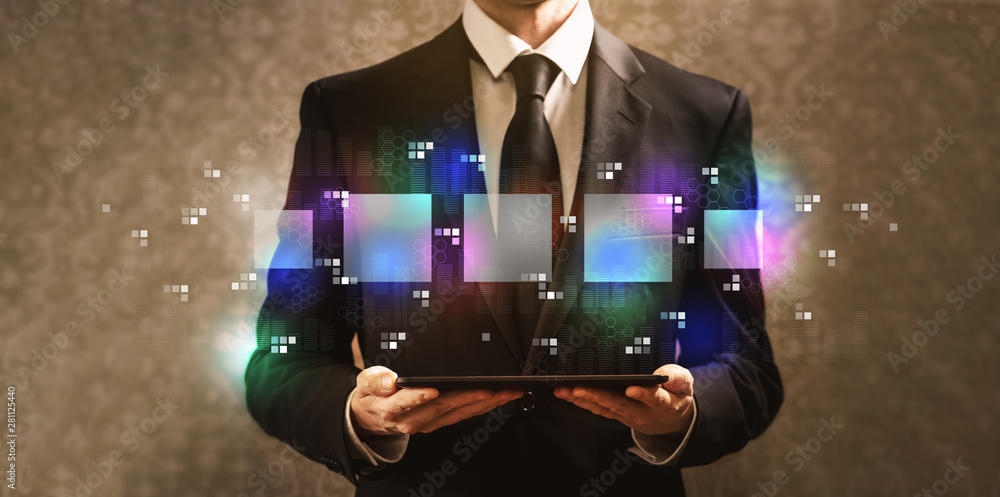 Digital square boxes with businessman holding a tablet computer on a dark vintage background