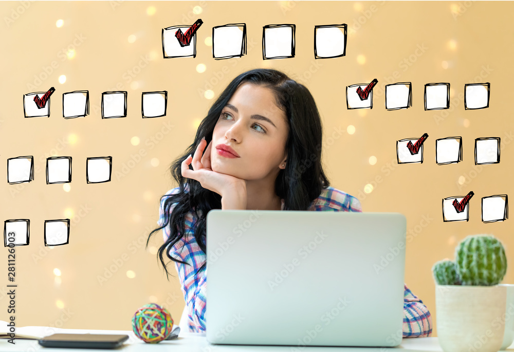 Checklist with young woman using a laptop