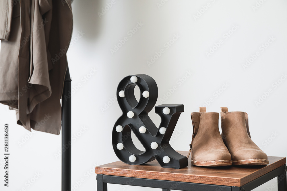 Female shoes with decor on table in hall