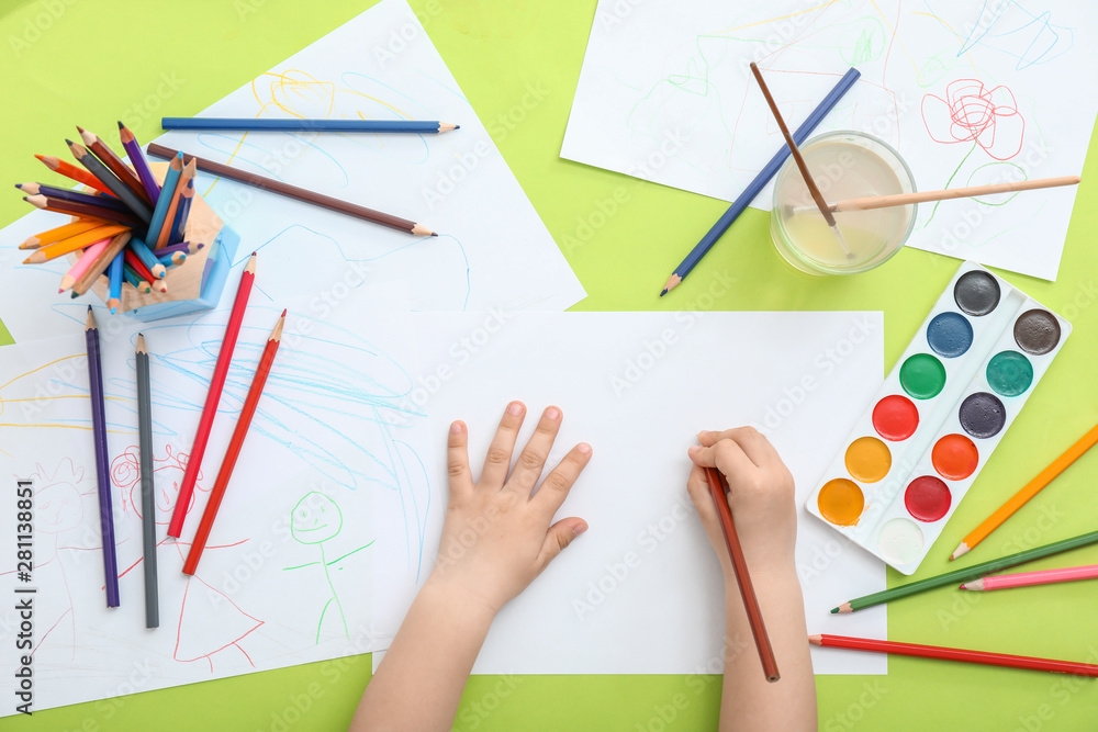 Cute little child drawing at table, top view