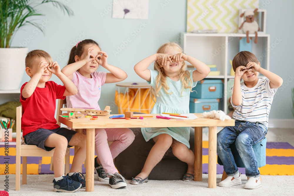 Cute little children playing in kindergarten