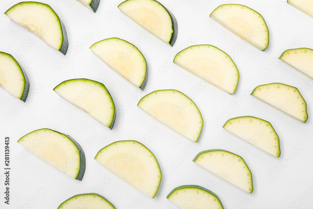 Slices of fresh zucchini on white background