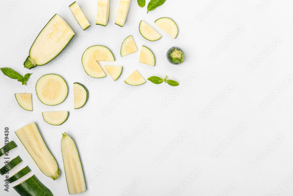 Composition with fresh cut zucchini on white background