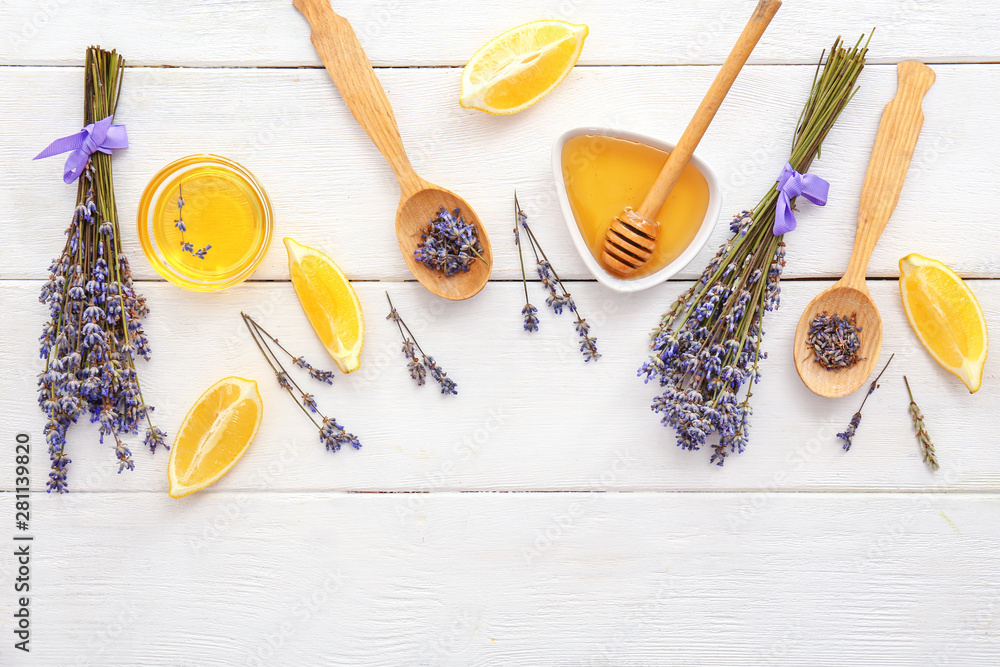 Lavender flowers with lemon and honey on white wooden background