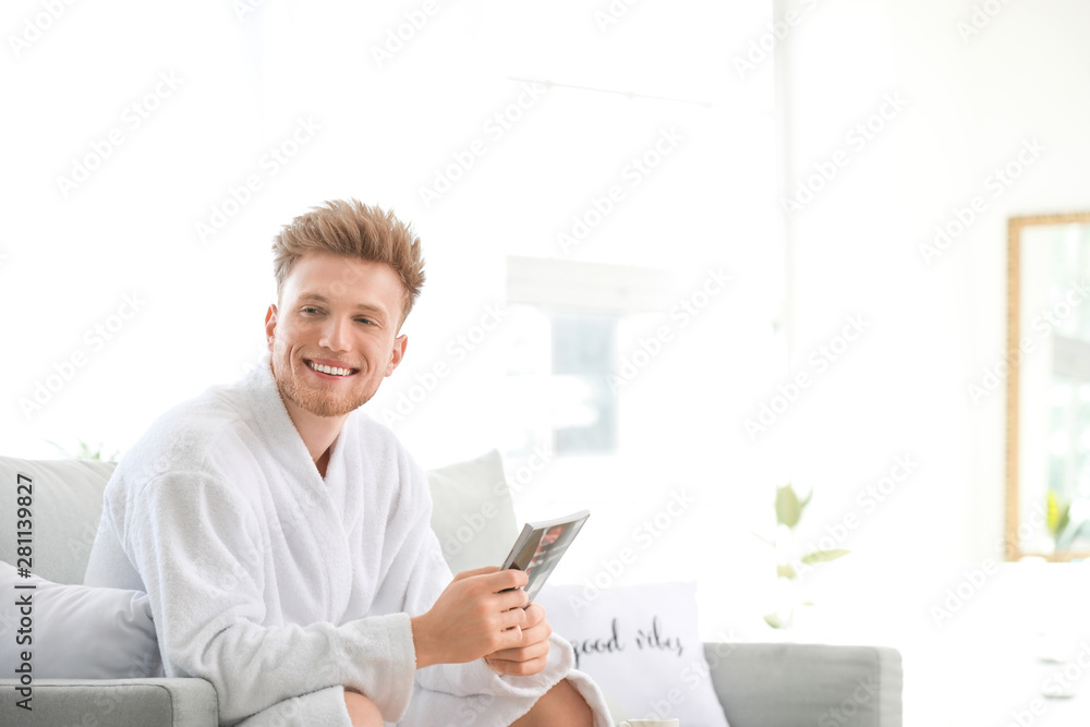 Morning of young man reading magazine at home