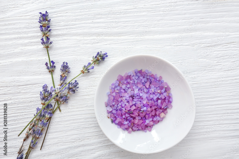 Sea salt with lavender on white wooden background