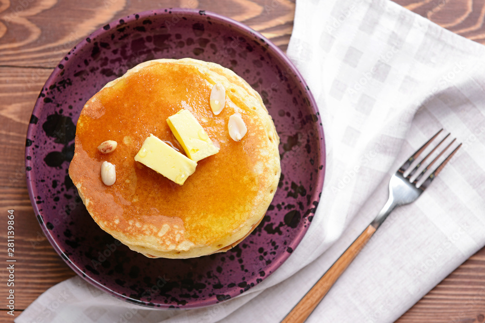 Tasty pancakes with butter on plate