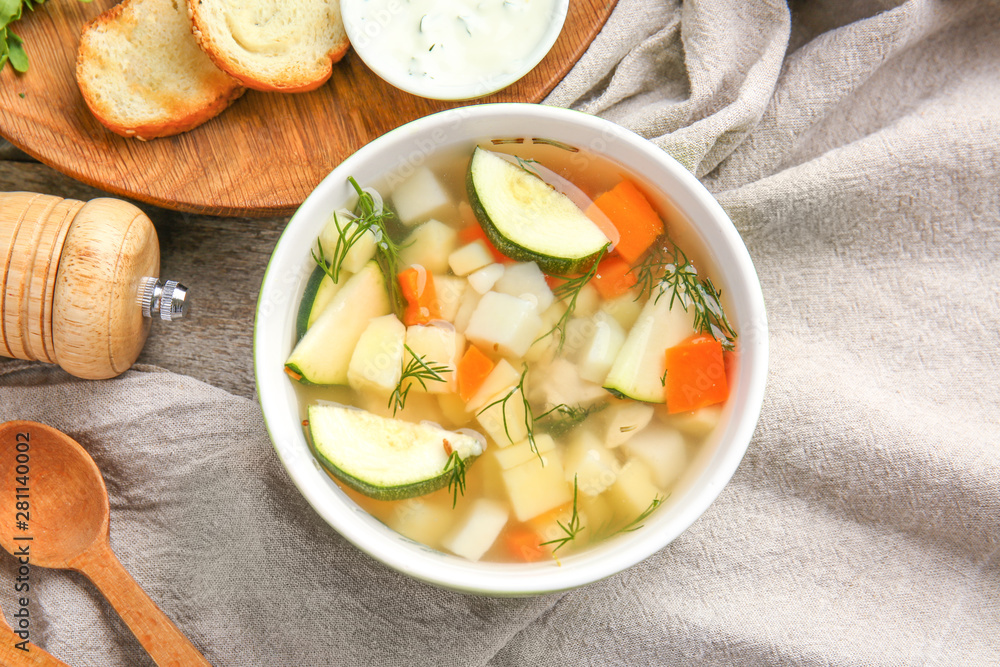 Bowl of tasty soup on table