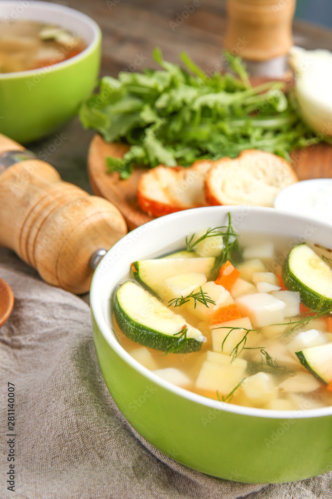 Bowl of tasty soup on table