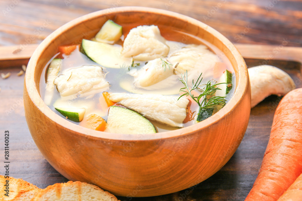 Bowl of tasty soup on table