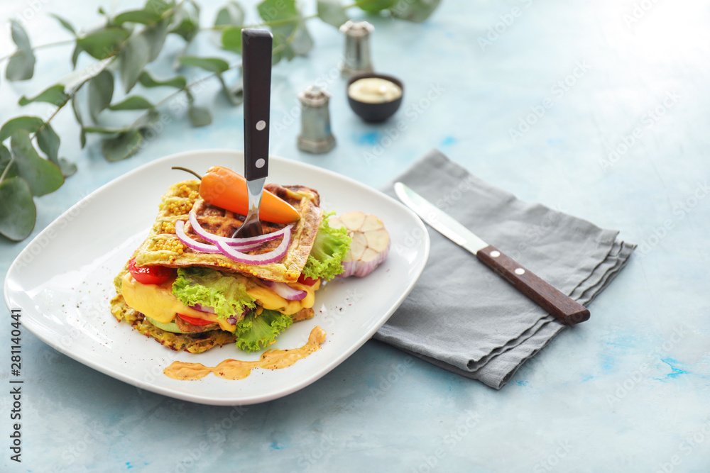 Plate with tasty squash waffles on table